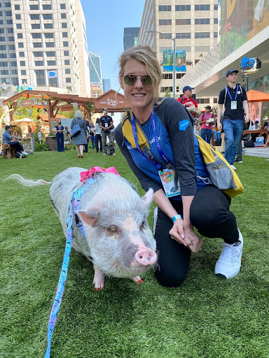 Amy Wood with Lilou the pig at Dreamforce 2021. Lilou the pig is a beloved therapy pig known for her role in providing comfort to individuals in various settings.