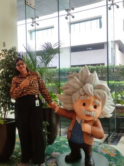 Lasya standing next to Salesforce character Einstein