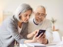 Two constituents navigate using government services on a mobile devices.