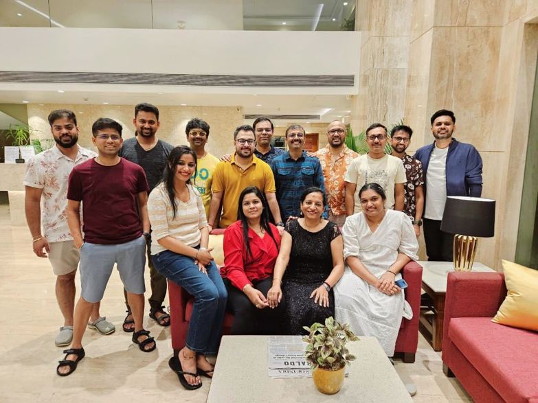 A group of Salesforce employees gather in a living room.