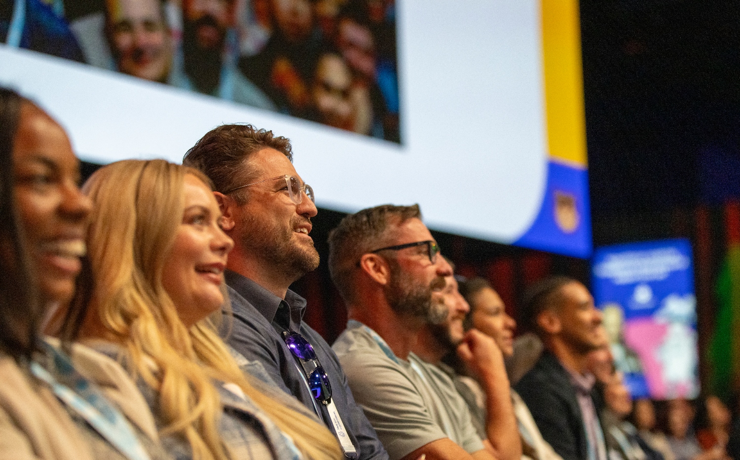Attendees at Dreamforce watching a presentation on stage.