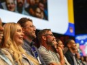 Attendees at Dreamforce watching a presentation on stage.