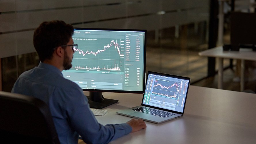 Busy business man uses software to track the success of his pricing strategies.