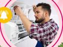 A male field service technician in a plaid shirt performs proactive maintenance on an A/C unit.