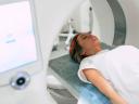 Young woman patient is ready to do magnetic resonance imaging in the modern hospital laboratory