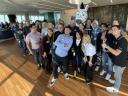 A group of AE Excellence Academy grads gather with Ziggy, the Salesblazer mascot