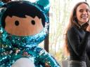 Alicia enjoying a coffee at Salesforce Dublin Tower, sitting on a green bench next to a big, blue sequined Astro plush