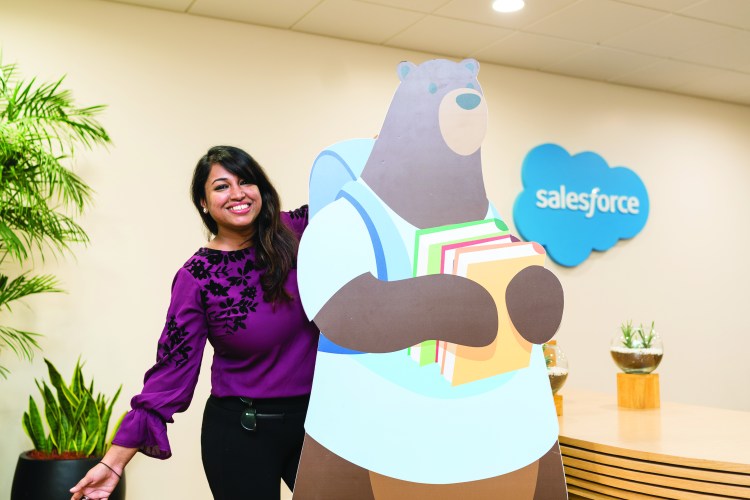 Yukti poses with a Codey cutout at Salesforce Hyderabad's welcome desk