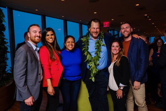 Ashley, her team, and Marc Benioff take a photo together in a Salesforce office.