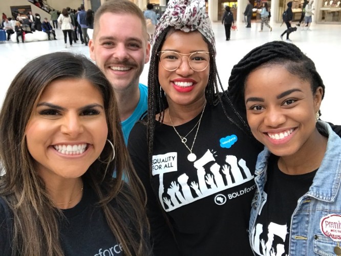 Ashley and three colleagues wearing Salesforce shirts
