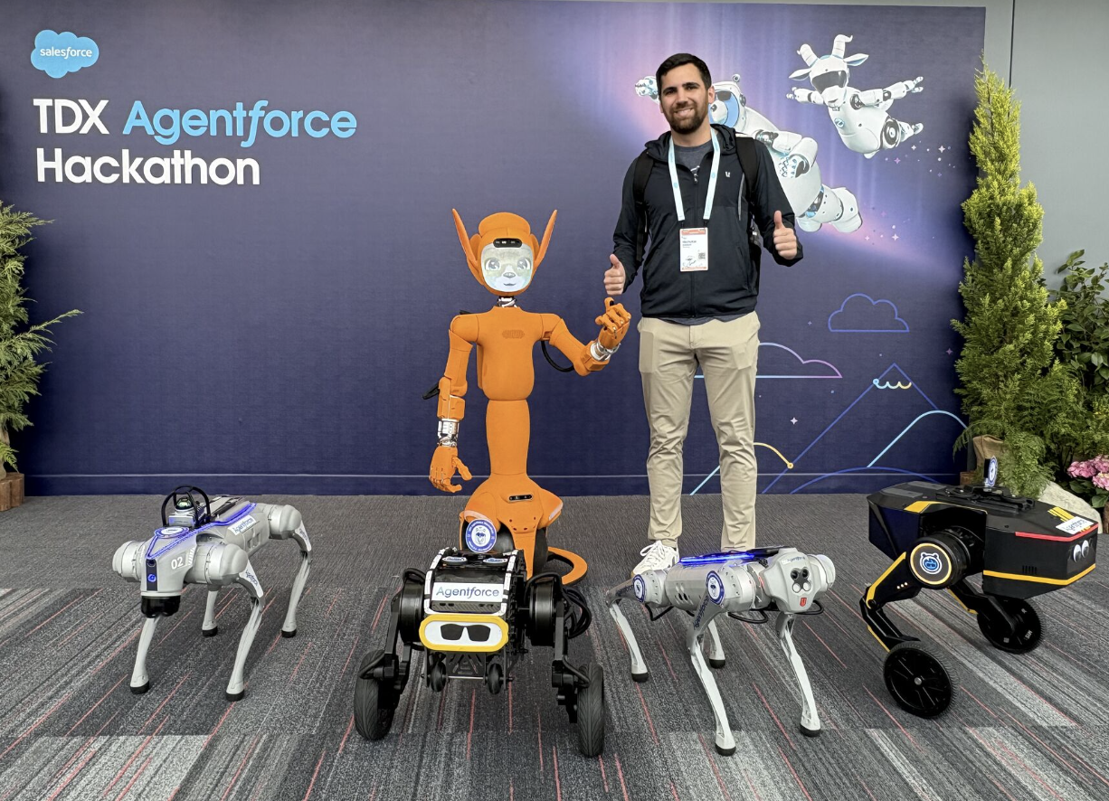 Nick stands with a line of robots in front of a "TDX Agentforce Innovation" backdrop