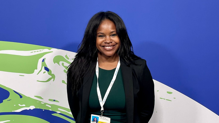 Bianca Williams in front of a blue backdrop depicting earth