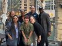 Sam poses with his team in front of the Chicago skyline