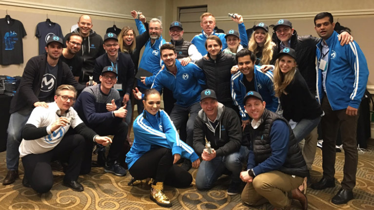 A group of MuleSoft colleagues wearing MuleSoft hats, shirts, and jackets.