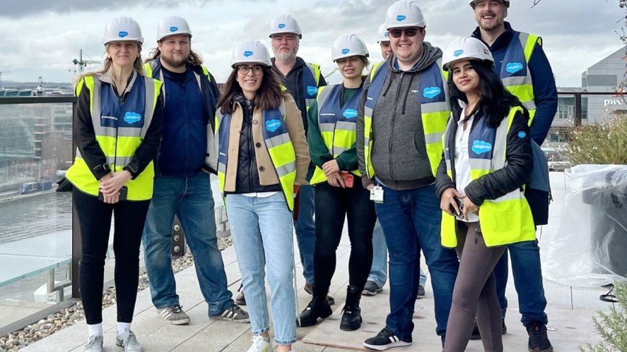 Ken and his team wearing hardhats and reflective vests visit a construction customer's site.