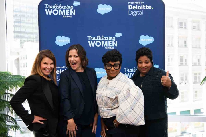 Four women in front of a blue Salesforce Trailblazing Women step and repeat