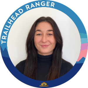 Kelsey Jackson's headshot in a circular Trailhead Ranger frame