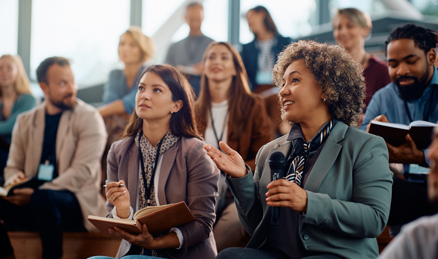 A group of small business owners together in an AI conference amphitheater.