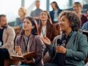 A group of small business owners together in an AI conference amphitheater.