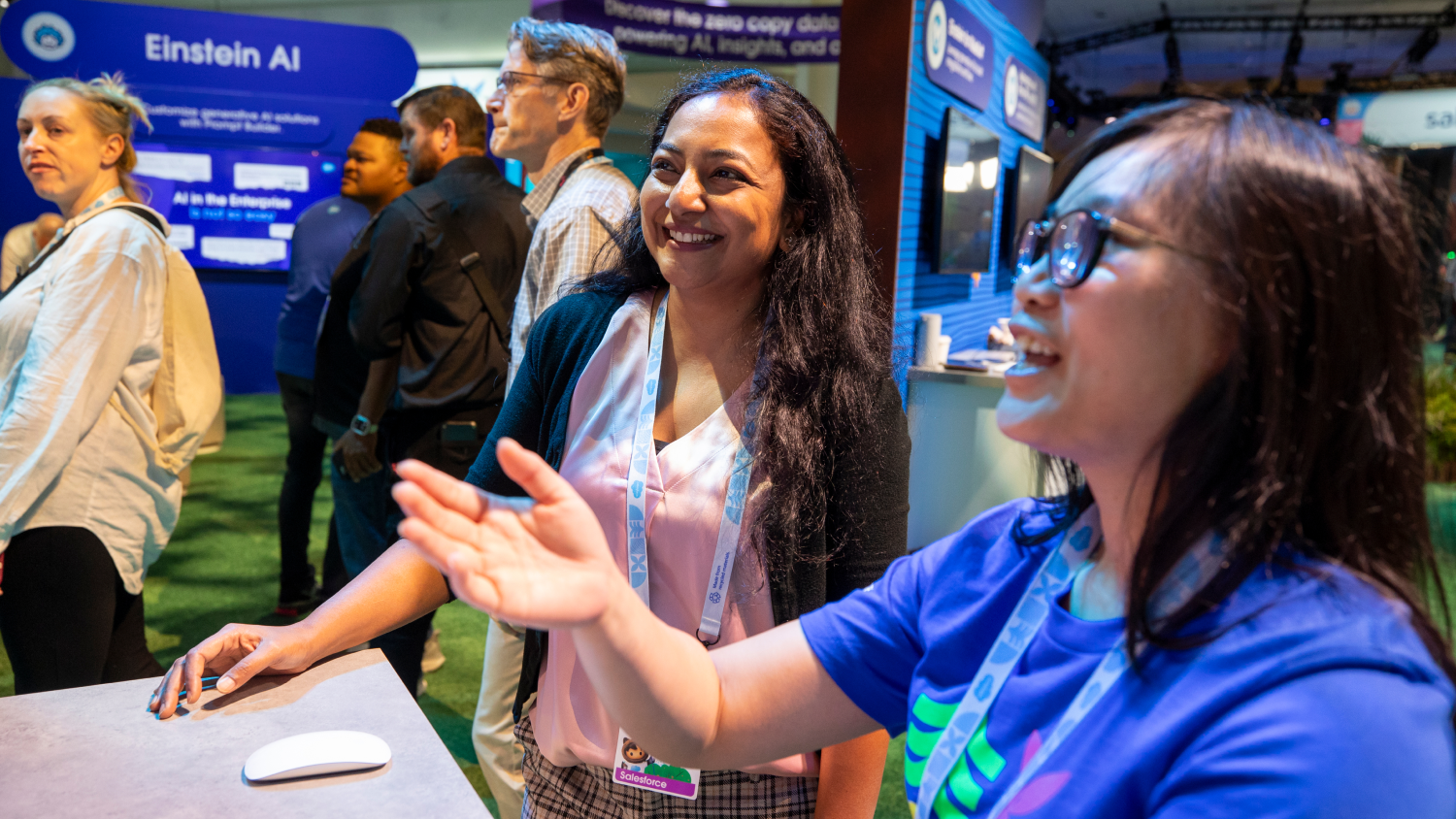 Two women look at exhibits at Dreamforce