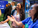 Two women look at exhibits at Dreamforce