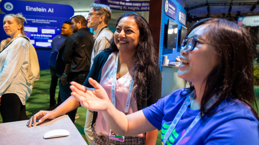 Two women look at exhibits at Dreamforce