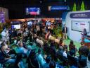 A group of attendees at Dreamforce 2024 sit in and watch two presenters deliver a Salesforce on Salesforce presentation