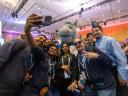 A group of smiling people huddle together for a selfie at Dreamforce.