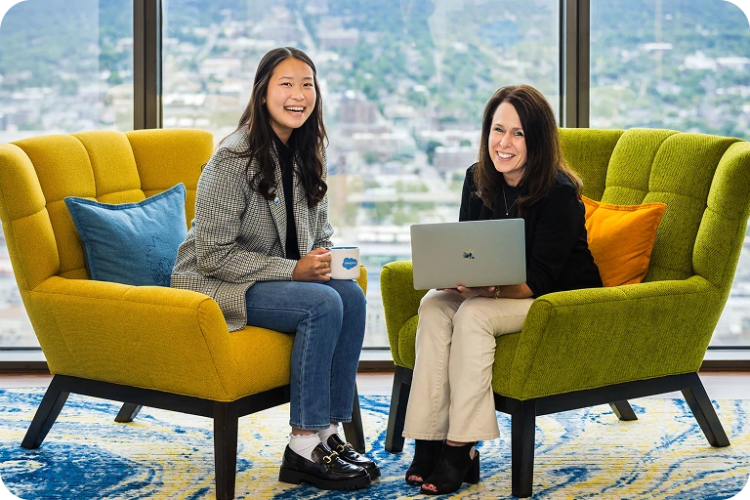 Two Salesforce Employees smiling at the camera.