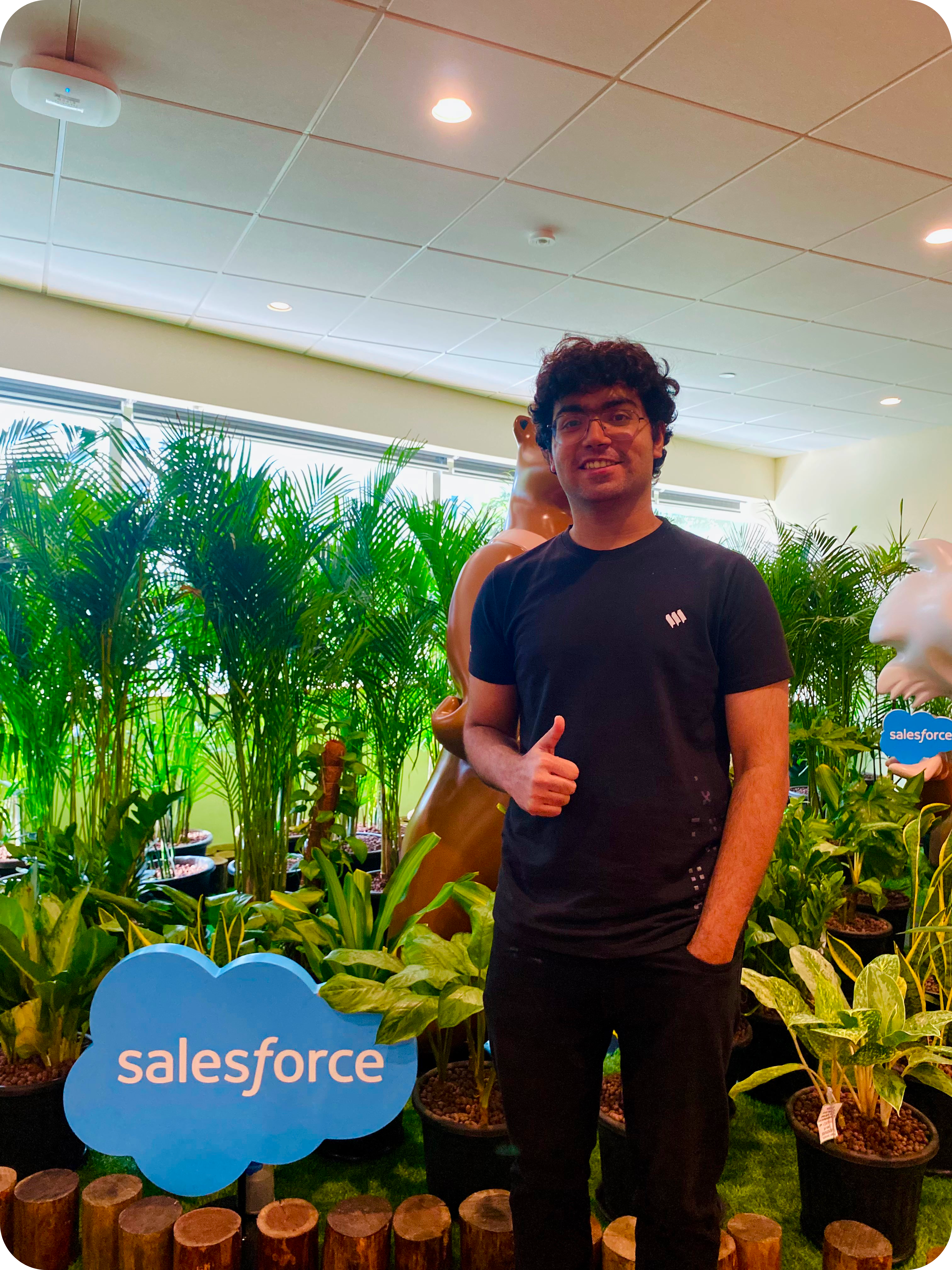 Intern in India taking a photo in the office.