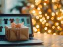 A computer with gifts on top showing holiday marketing AI SEO strategies in front of a Christmas tree.