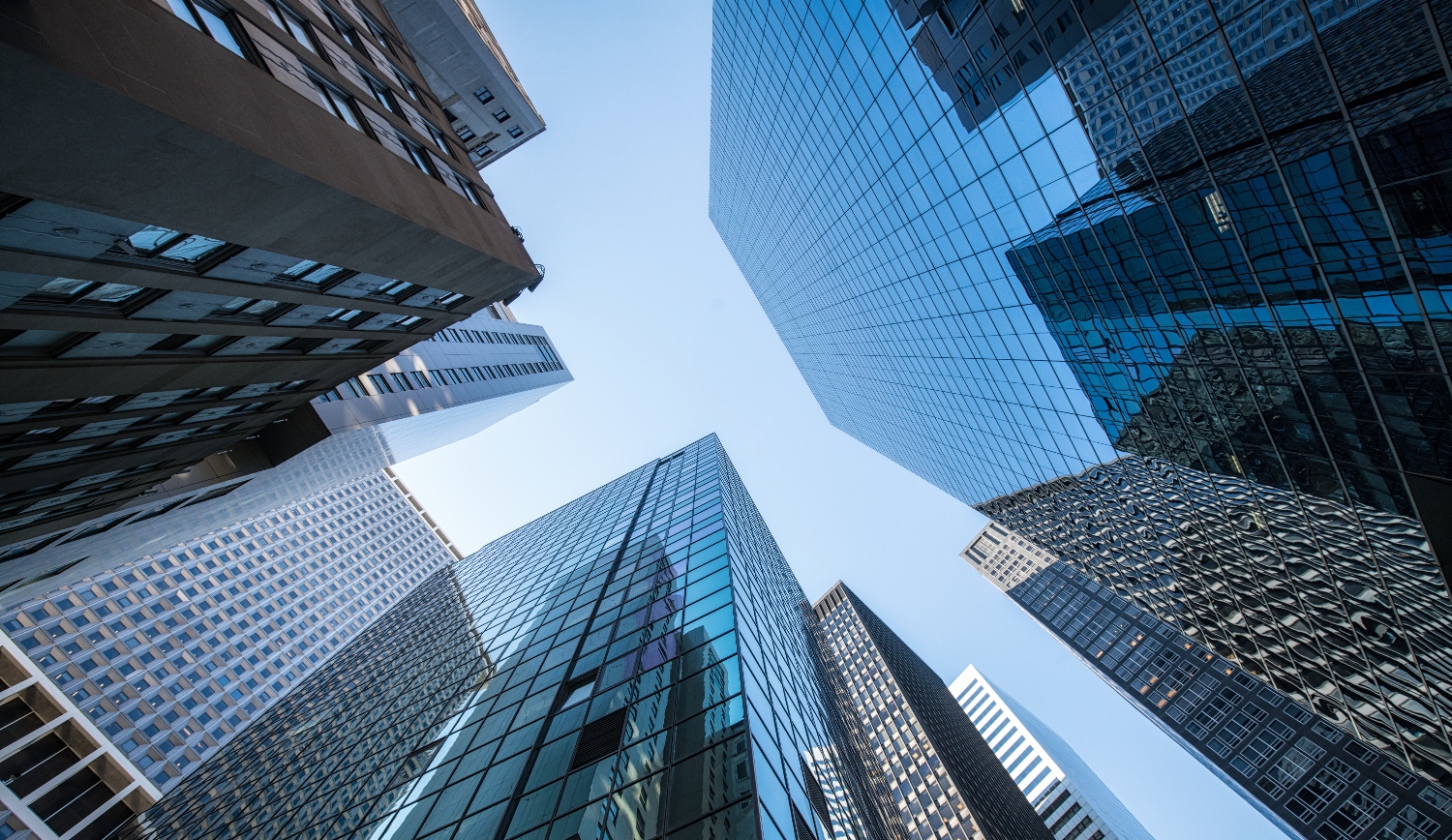 Building skyscraper ground view, tall buildings with sunrise.