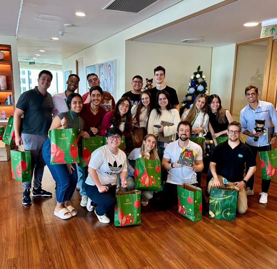 Futureforce members holding christmas bags and posing together.
