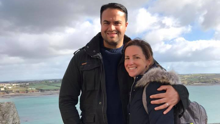 Omar and his wife posing for a photo.