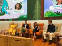 A panel of four professionals is engaged in a discussion on stage at a Salesforce event.