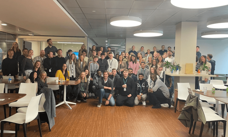 A large group of Salesforce employees are posing for a photo in the offices of the company in Dublin.