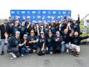 A group of smiling Salesforce employees posing together for a photo.