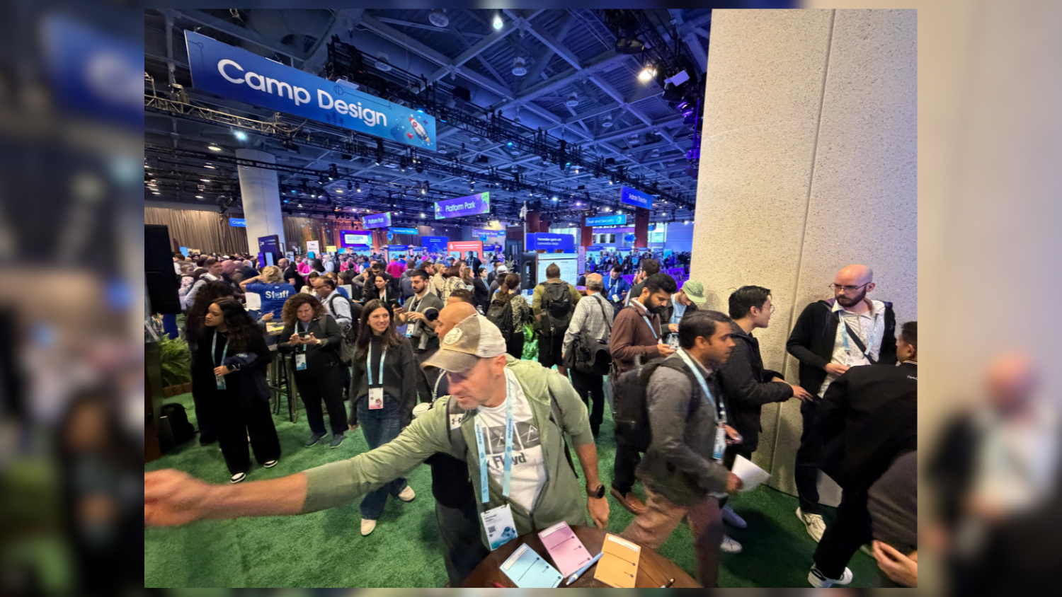 A crowd of attendees at Dreamforce. The Camp Design sign hangs from the rafters in the background.