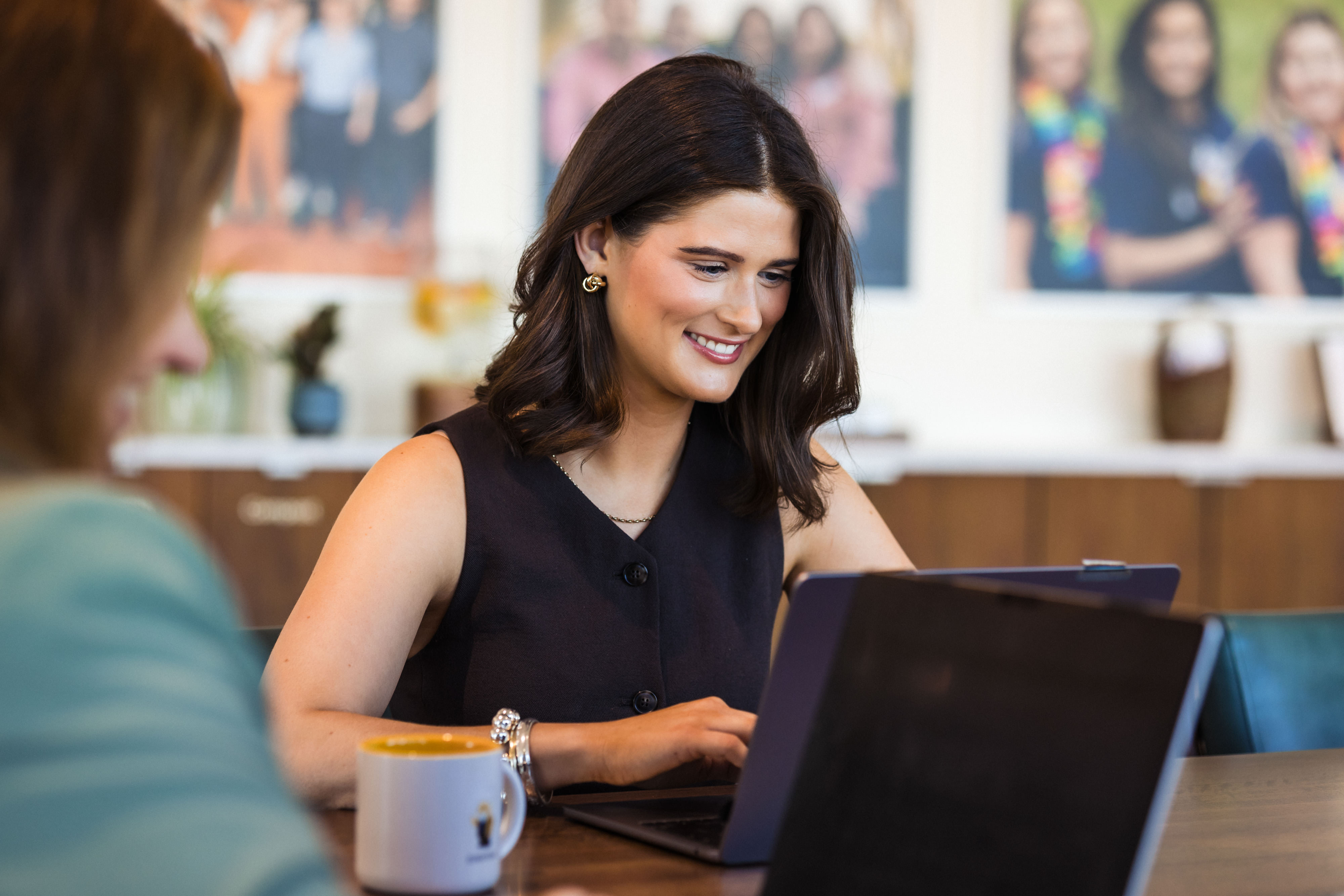 woman sits at her computer in a modern office space