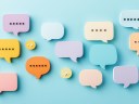 Illustration of several speech bubbles in color on a blue background simulating team communication.