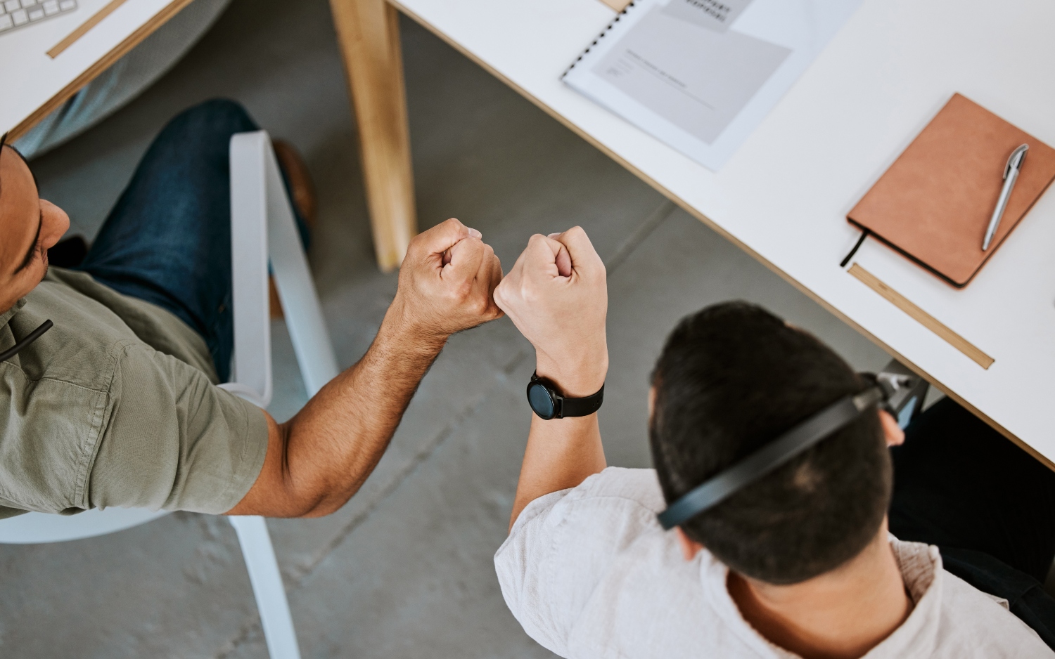 Excited call centre agents, fist bump and celebrating deal, promotion and sale from above in office.