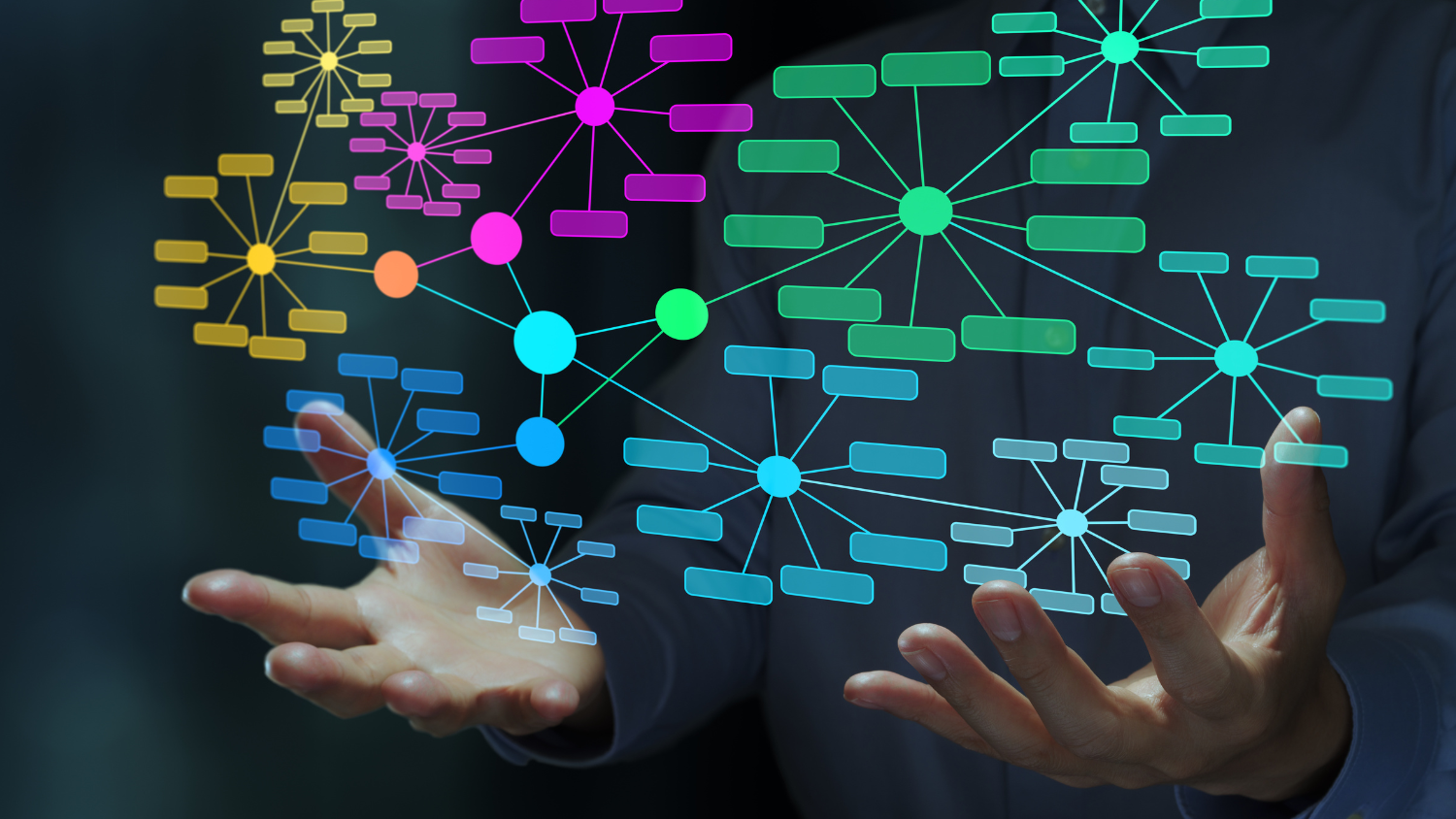 Colorful network diagrams floating above a pair of hands.
