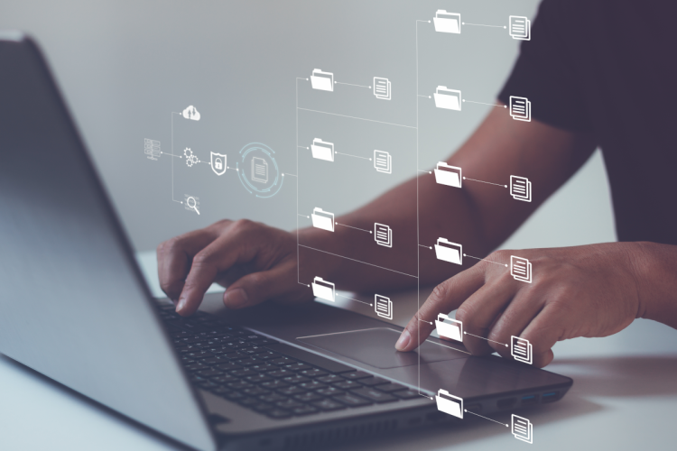 Icons of various files appears over a laptop.