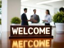 An office setting with a sign welcoming new customers in onboarding.