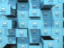 A line of bright blue filing cabinets opening against a wall, symbolizing resource management.