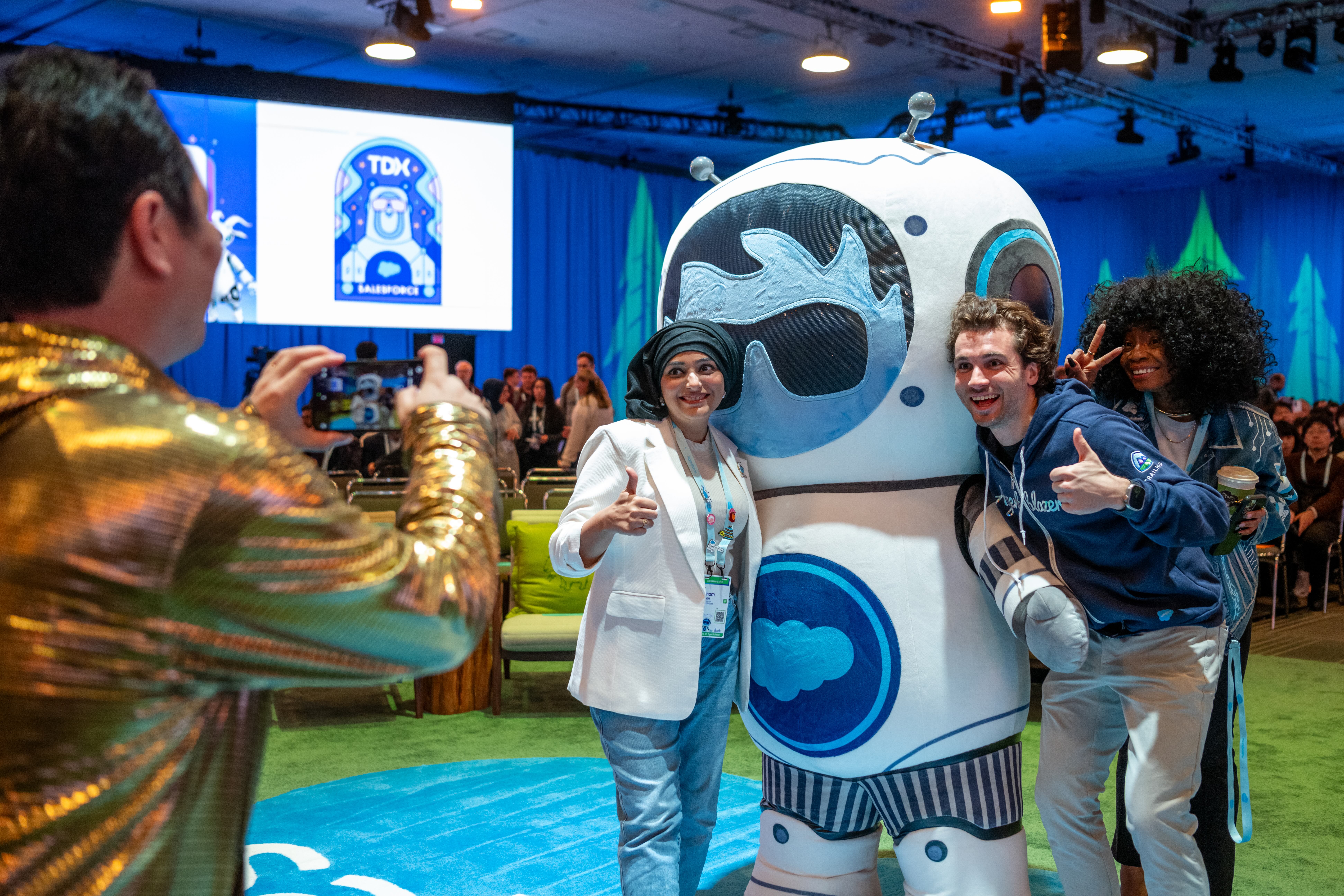TDX event attendees taking a photo with Agent Astro.