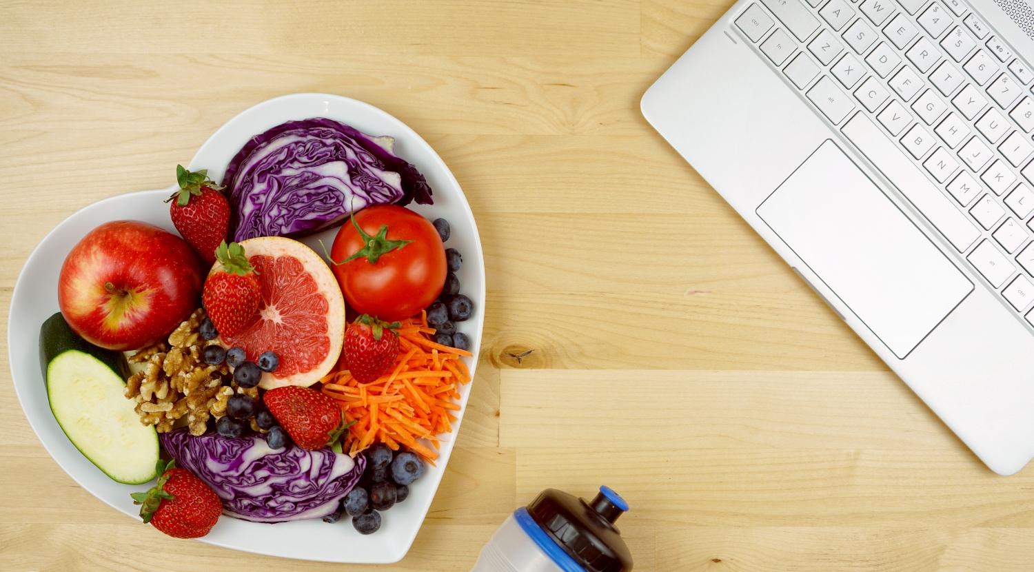 Stethoscope, healthy fresh food and exercise equipment, showcasing small business wellness program.