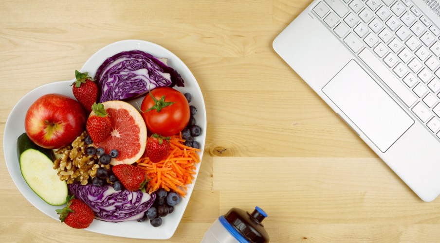 Stethoscope, healthy fresh food and exercise equipment, showcasing small business wellness program.