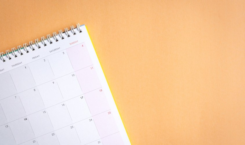 Close-up of a Calendar on Orange Background. Showing National SMB week.