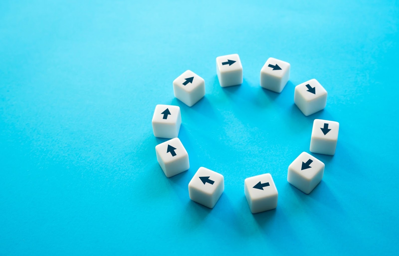 A set of dice with arrows on them set in a circle on a blue background, showing customer feedback loops.